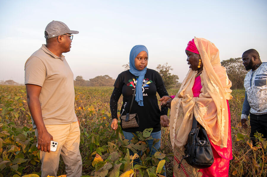 Terra team talking with a farmer in the field in Guinea